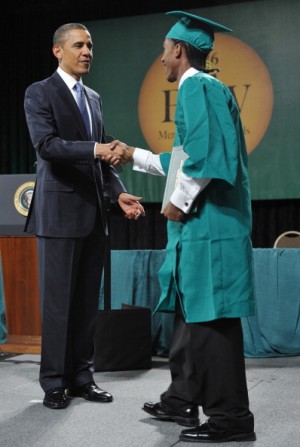 President Obama greets a graduate of Booker T. Washington High School during the school's May 2011 graduation ceremony. Obama called the school one of the country's most inspiring.