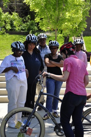 Students listen to WABA instructor Sarah Miller explain how to check a bike before going for a ride.
